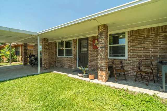 a backyard of a house with yard and outdoor seating