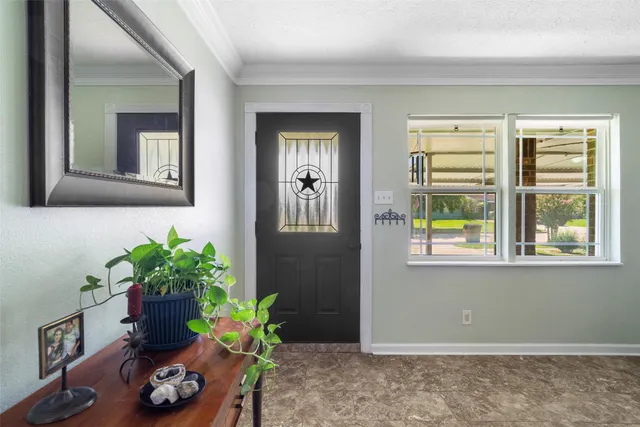 a vase with flowers sitting on a floor