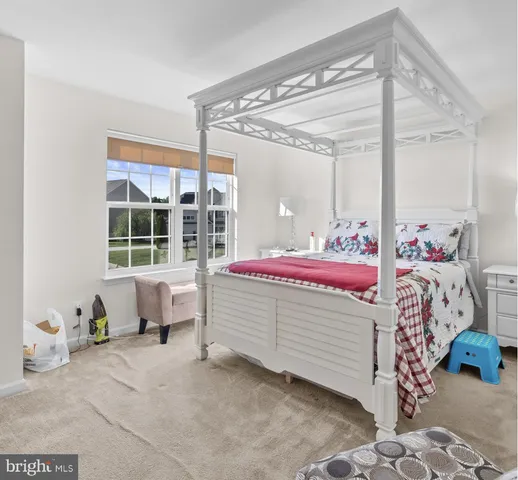 a spacious bathroom with a toilet a sink and mirror