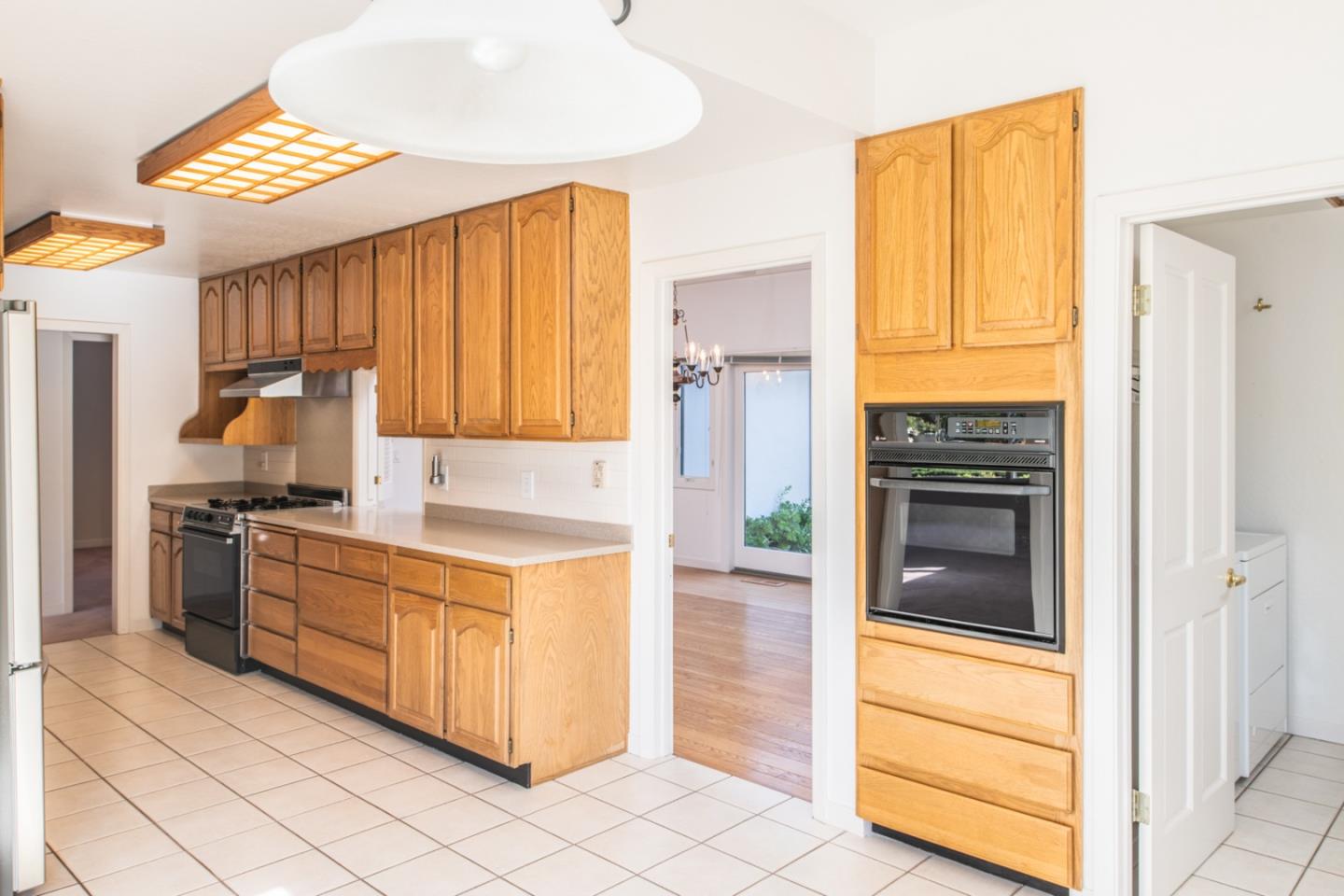 3049 Cormorant Road Pebble Beach, CA 93953 - Photo 13 of 42 a kitchen with stainless steel appliances granite countertop a stove a refrigerator and a microwave