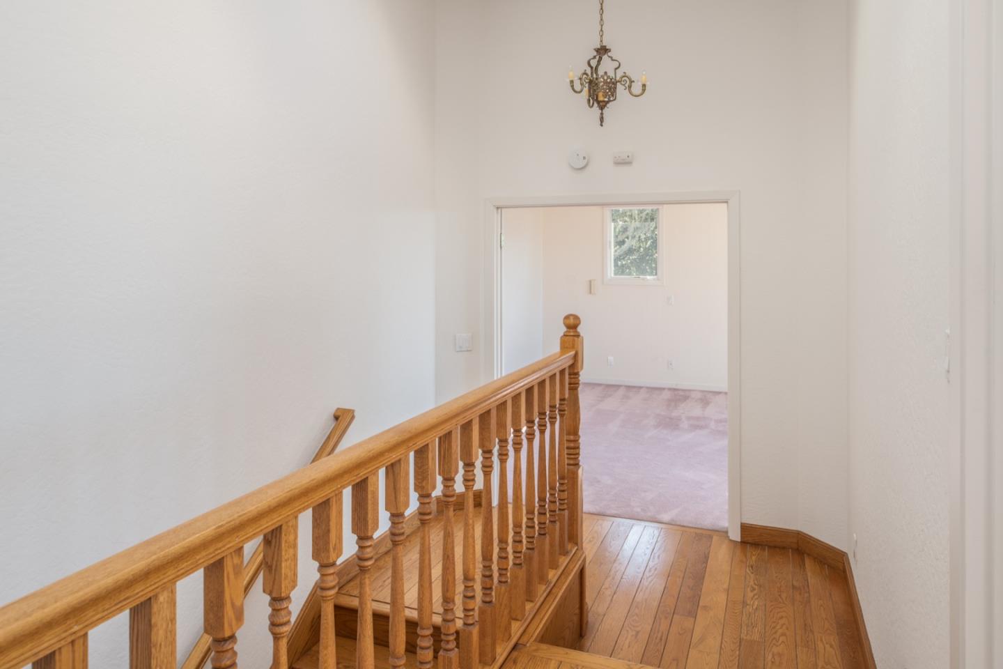 3049 Cormorant Road Pebble Beach, CA 93953 - Photo 24 of 42 a view of a hallway with wooden floor and staircase