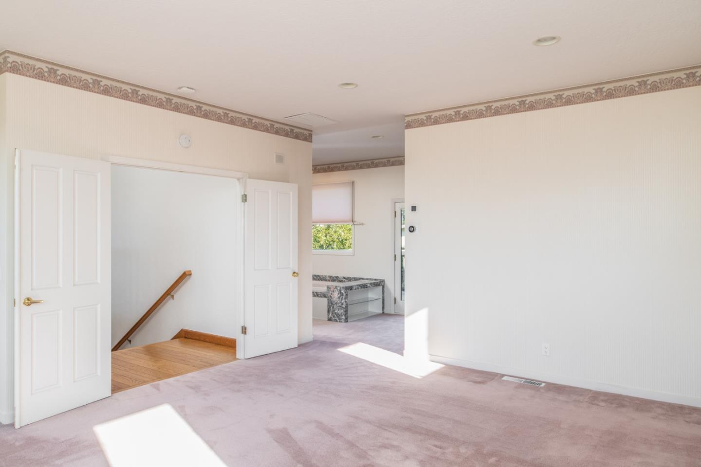 3049 Cormorant Road Pebble Beach, CA 93953 - Photo 29 of 42 a view of empty room with wooden floor and window