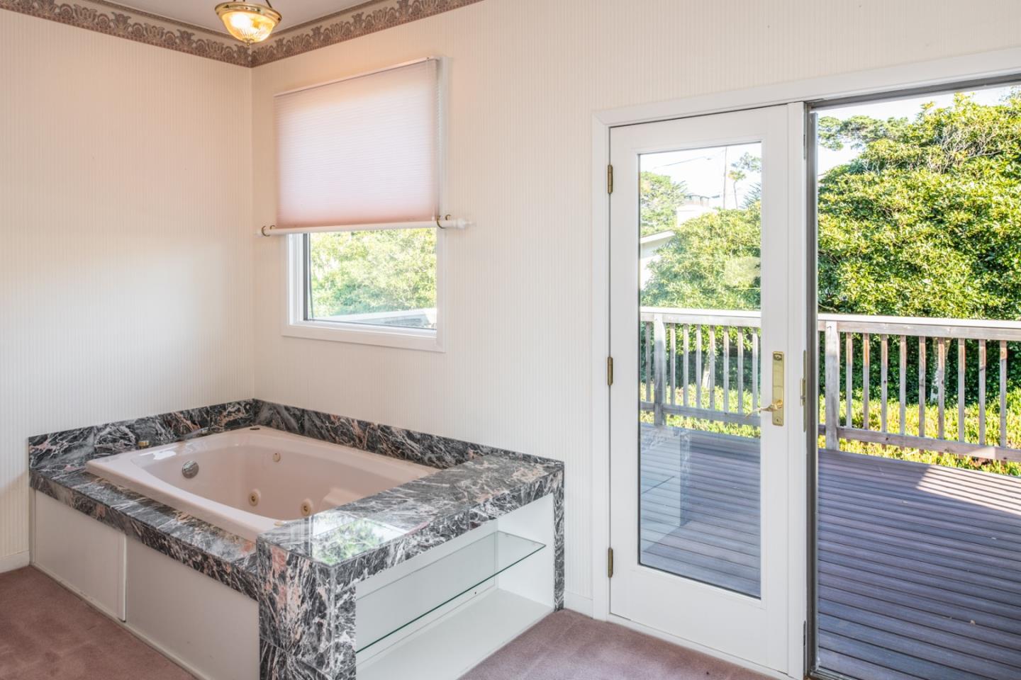 3049 Cormorant Road Pebble Beach, CA 93953 - Photo 30 of 42 a bathroom with a granite countertop sink and a window