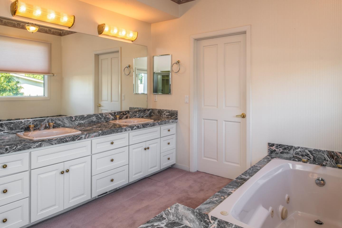 3049 Cormorant Road Pebble Beach, CA 93953 - Photo 31 of 42 a bathroom with a tub sink and mirror