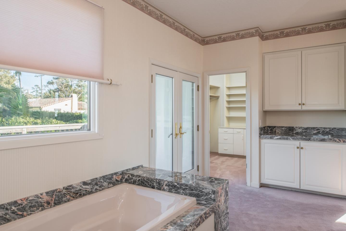 3049 Cormorant Road Pebble Beach, CA 93953 - Photo 33 of 42 a spacious bathroom with a granite countertop tub sink and mirror