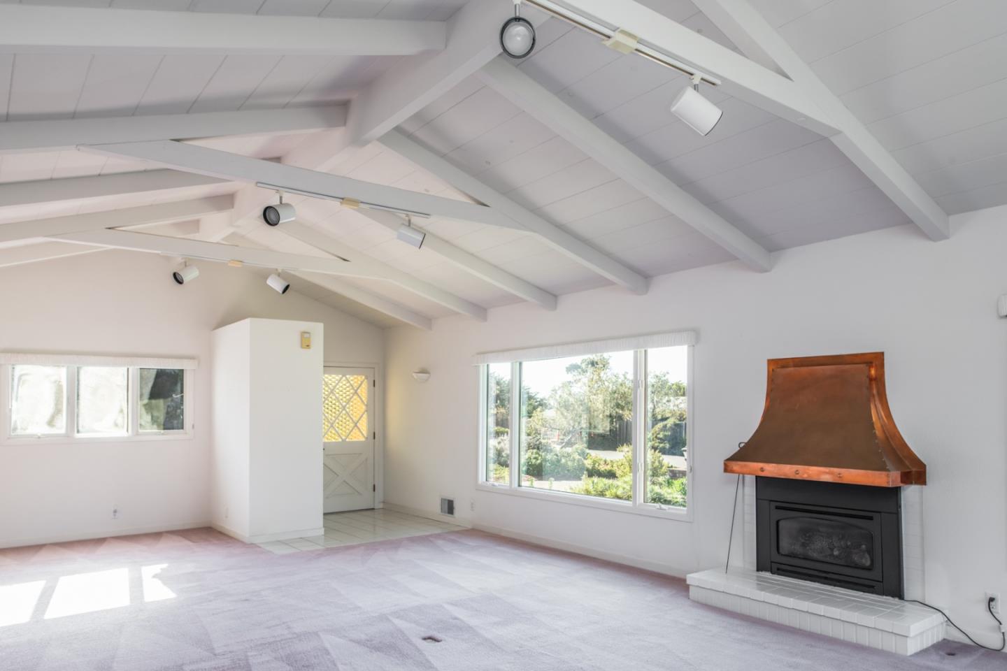 3049 Cormorant Road Pebble Beach, CA 93953 - Photo 7 of 42 an empty room with windows and fireplace