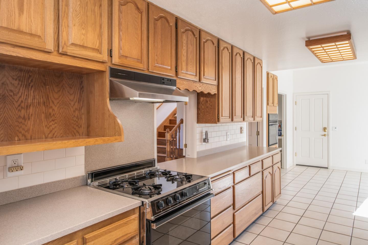 3049 Cormorant Road Pebble Beach, CA 93953 - Photo 10 of 42 a kitchen with granite countertop a stove and a sink