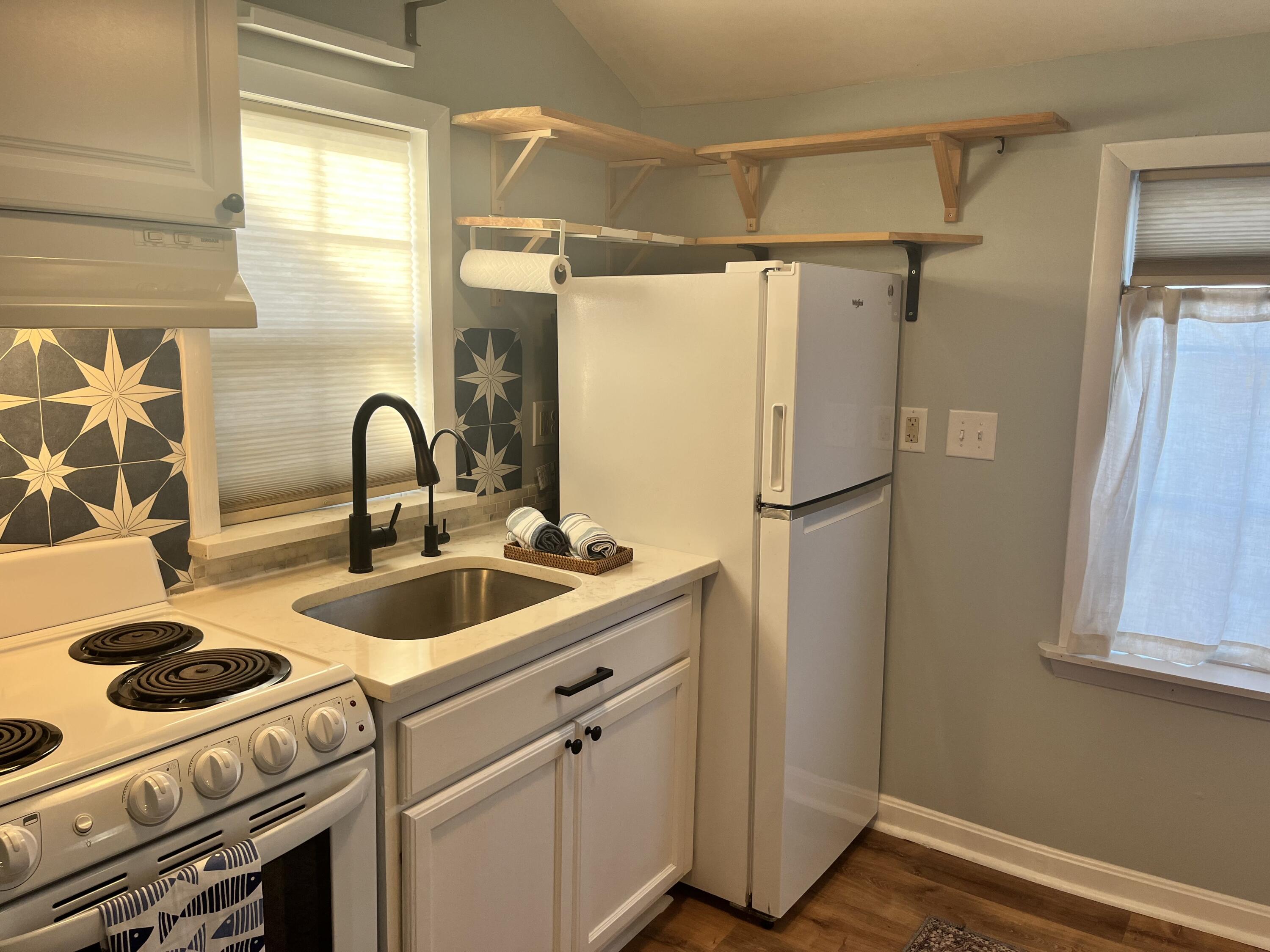 8 Trinity Lane Wareham, MA 02571 - Photo 13 of 49 a kitchen with sink a refrigerator and a stove