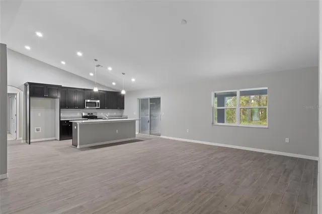 a large kitchen with kitchen island a sink stainless steel appliances and cabinets