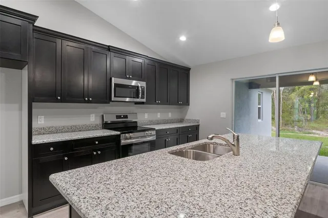 a kitchen with sink cabinets and outdoor view