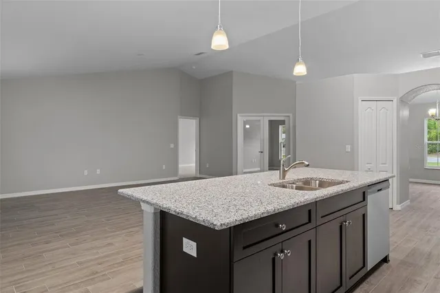 a kitchen with a sink a vanity island and wooden floor