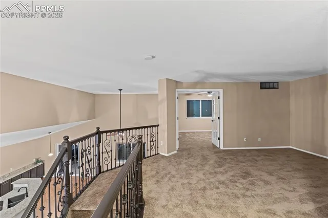 a view of a livingroom with wooden floor and stairs