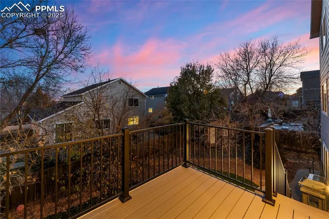 a view of balcony with wooden floor and trees
