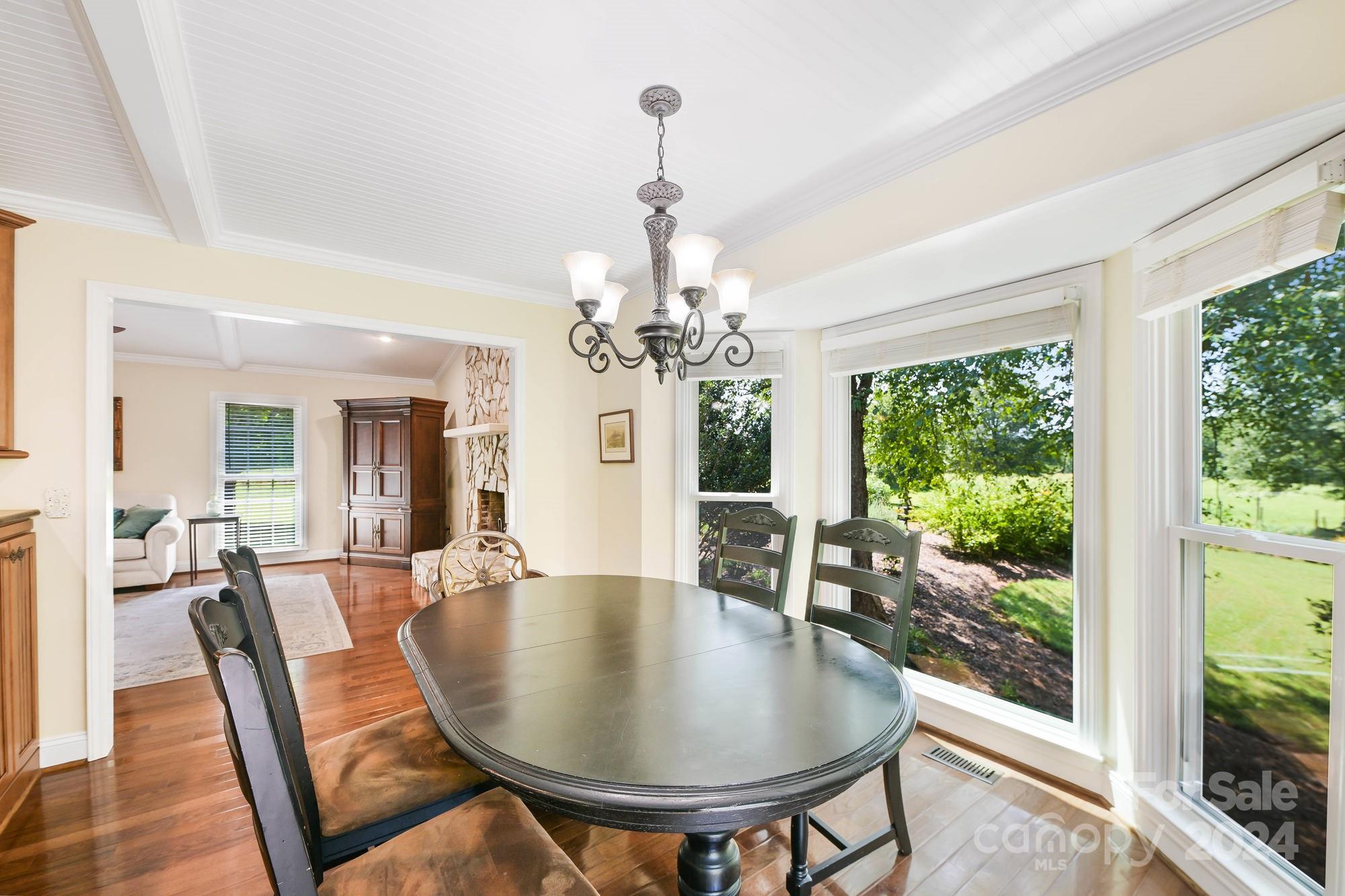 1135 Arabian Farm Road Clover, SC 29710 - Photo 12 of 48 a dining room with furniture a chandelier and wooden floor