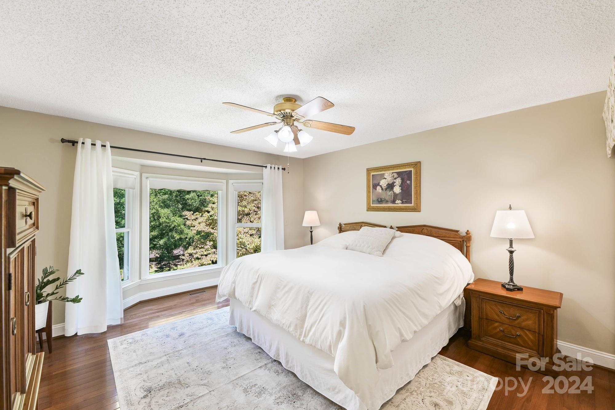 1135 Arabian Farm Road Clover, SC 29710 - Photo 13 of 48 a bedroom with a large bed and a chandelier