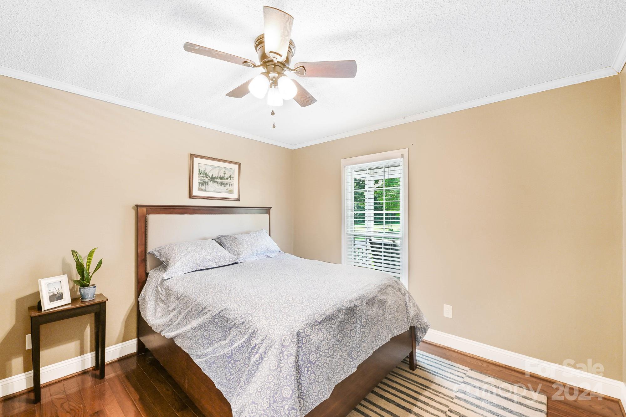 1135 Arabian Farm Road Clover, SC 29710 - Photo 17 of 48 a bedroom with a bed and a chandelier