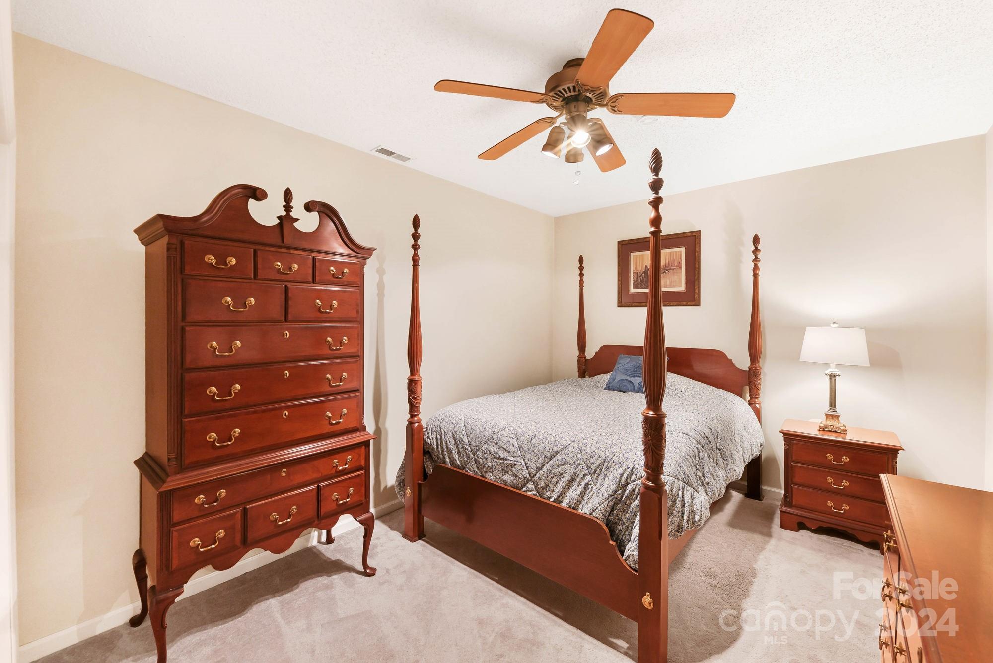 1135 Arabian Farm Road Clover, SC 29710 - Photo 21 of 48 a bedroom with a bed and a chandelier
