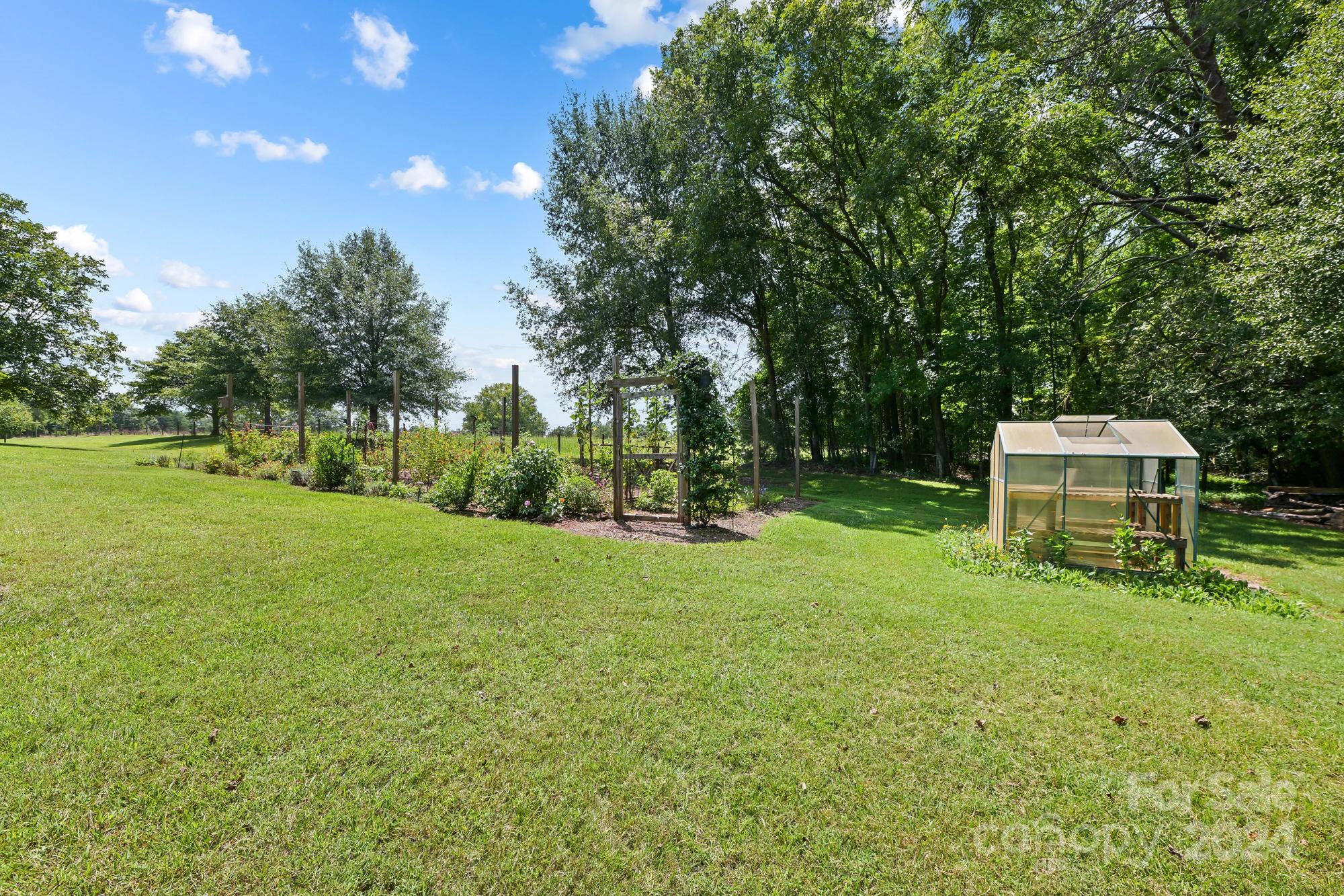 1135 Arabian Farm Road Clover, SC 29710 - Photo 34 of 48 a backyard of a house with table and chairs