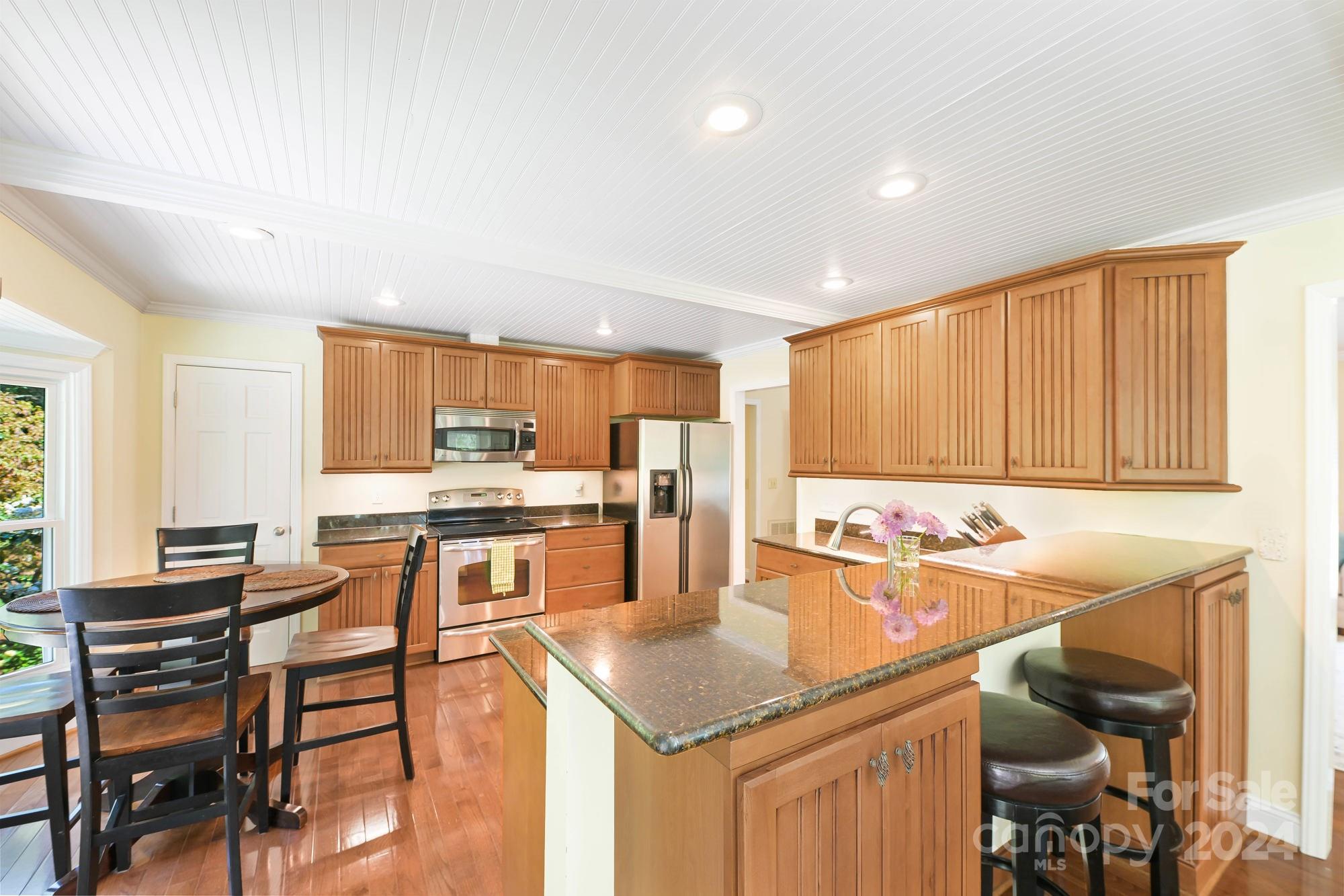 1135 Arabian Farm Road Clover, SC 29710 - Photo 8 of 48 a kitchen with a sink and chairs
