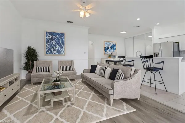a living room with furniture a large window and a flat screen tv
