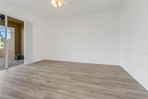 a view of an empty room and wooden floor