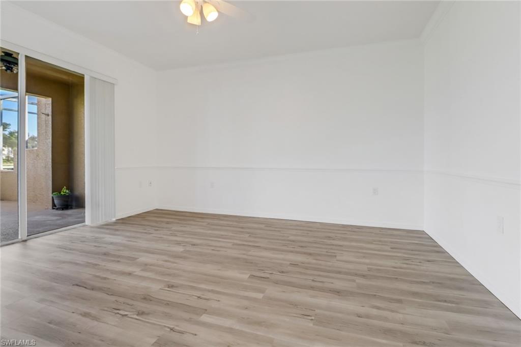 1677 Morning Sun Lane Naples, FL 34119 - Photo 15 of 41 a view of an empty room and wooden floor