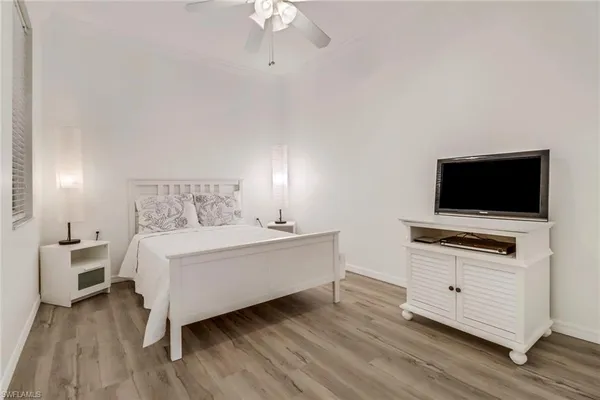 a room with a bed and a flat screen tv