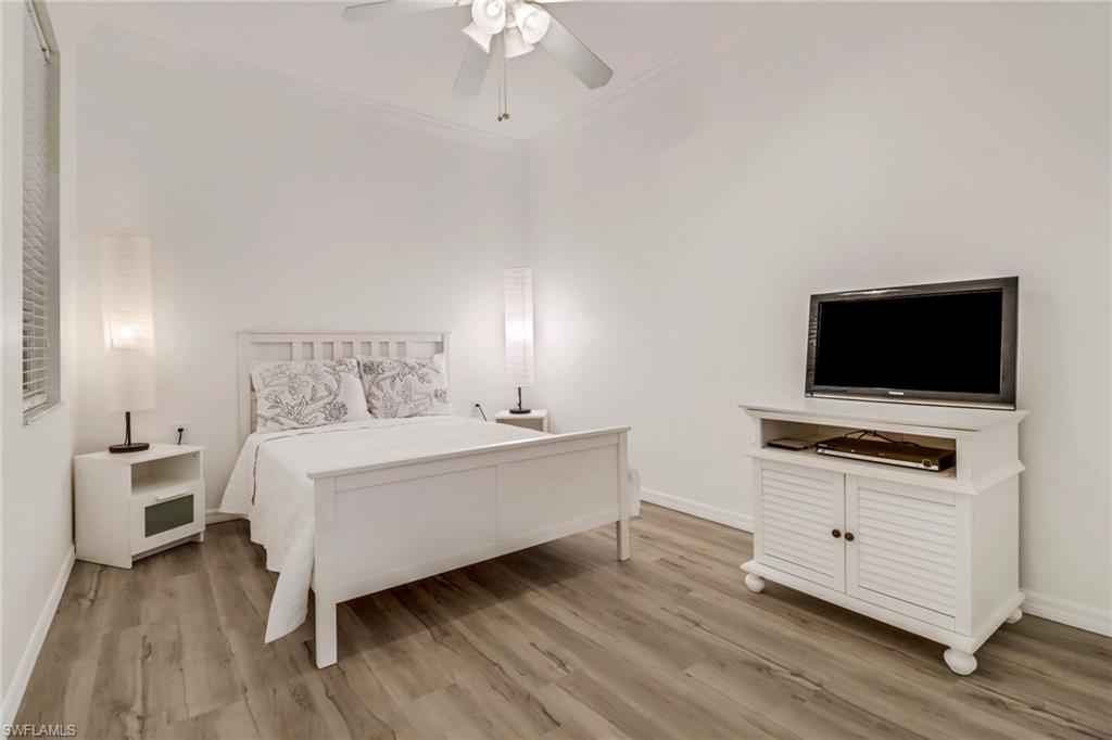 1677 Morning Sun Lane Naples, FL 34119 - Photo 20 of 41 a room with a bed and a flat screen tv
