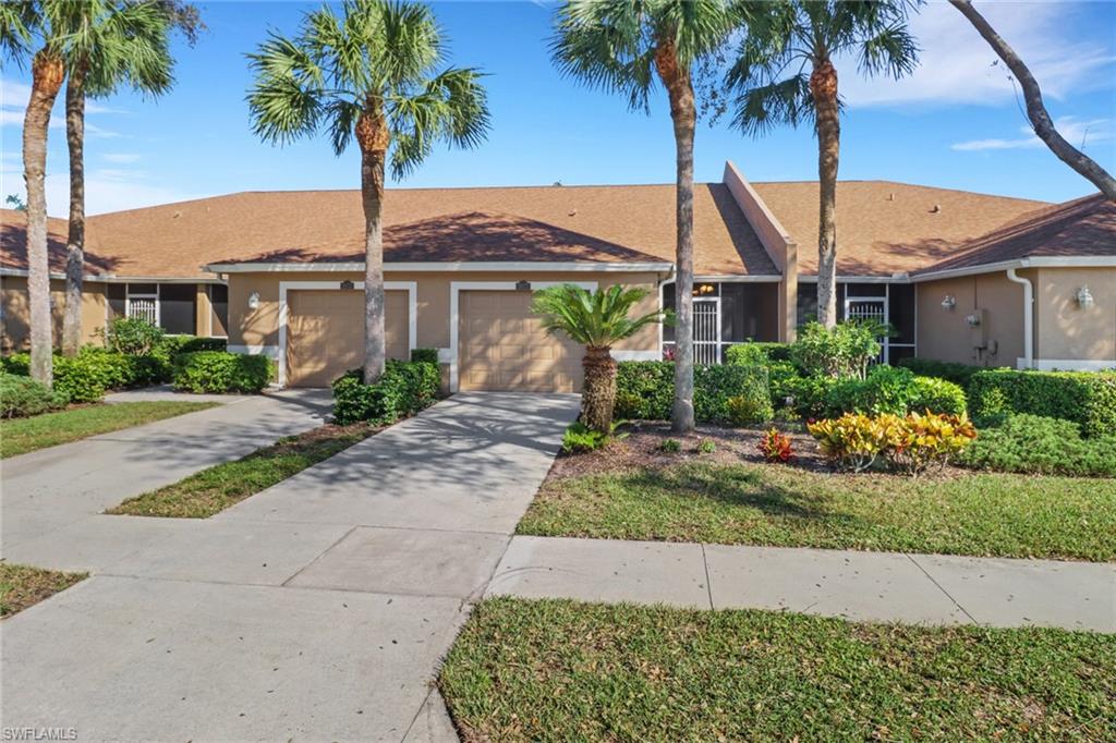 1677 Morning Sun Lane Naples, FL 34119 - Photo 2 of 41 a view of a yard in front of a house