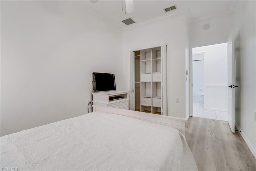 1677 Morning Sun Lane Naples, FL 34119 - Photo 21 of 41 a bedroom with a bed and a flat screen tv
