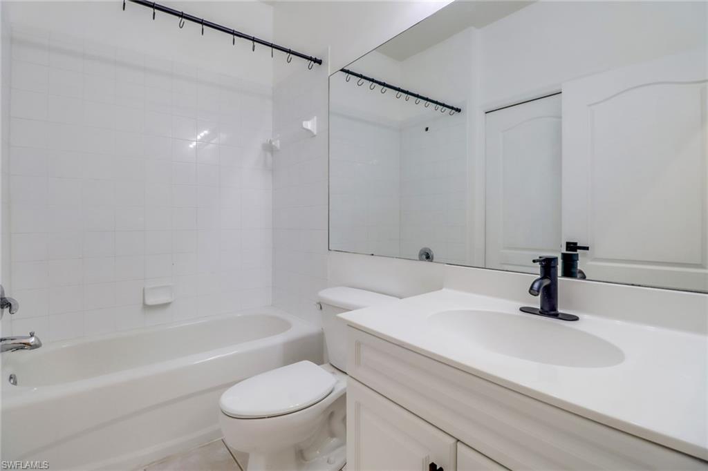 1677 Morning Sun Lane Naples, FL 34119 - Photo 22 of 41 a bathroom with a sink a toilet and a bathtub