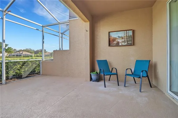 a view of an chairs and table in the room