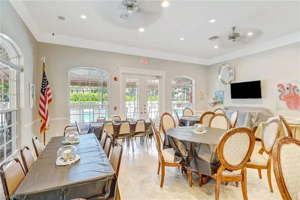 a view of a dining room with furniture a chandelier and window