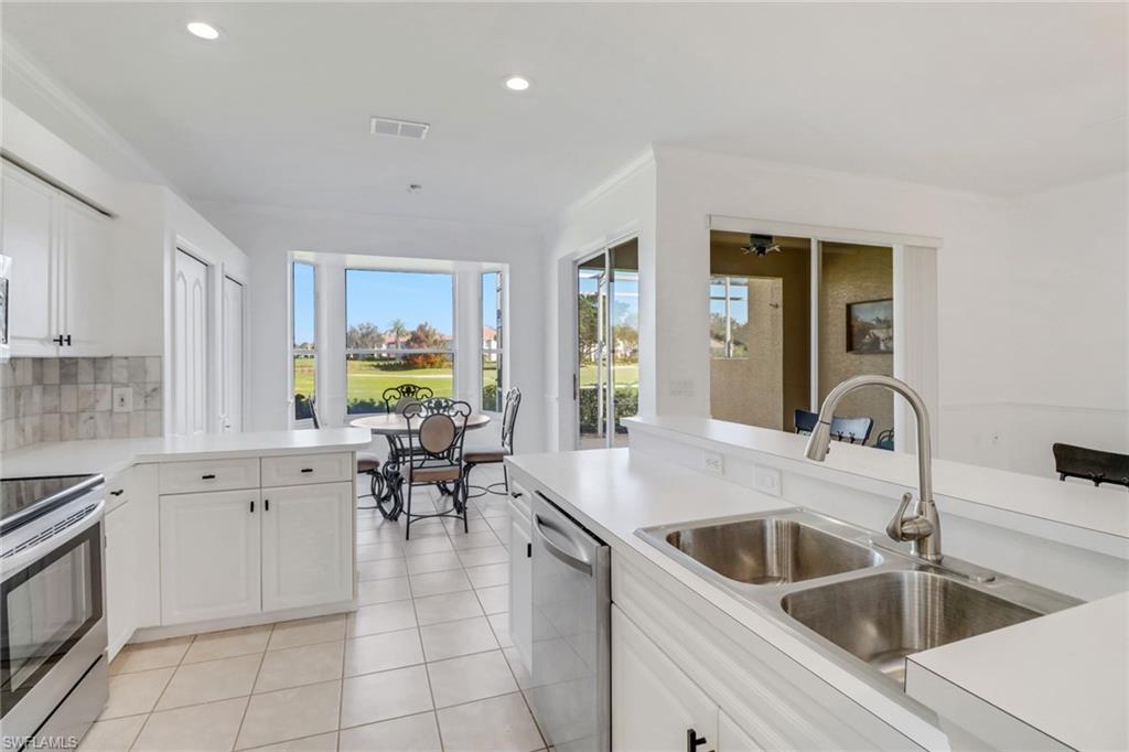 1677 Morning Sun Lane Naples, FL 34119 - Photo 9 of 41 a kitchen with a sink cabinets and counter space