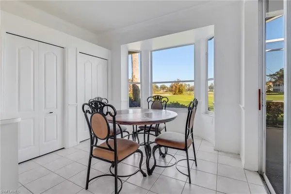 a dining room with furniture and window