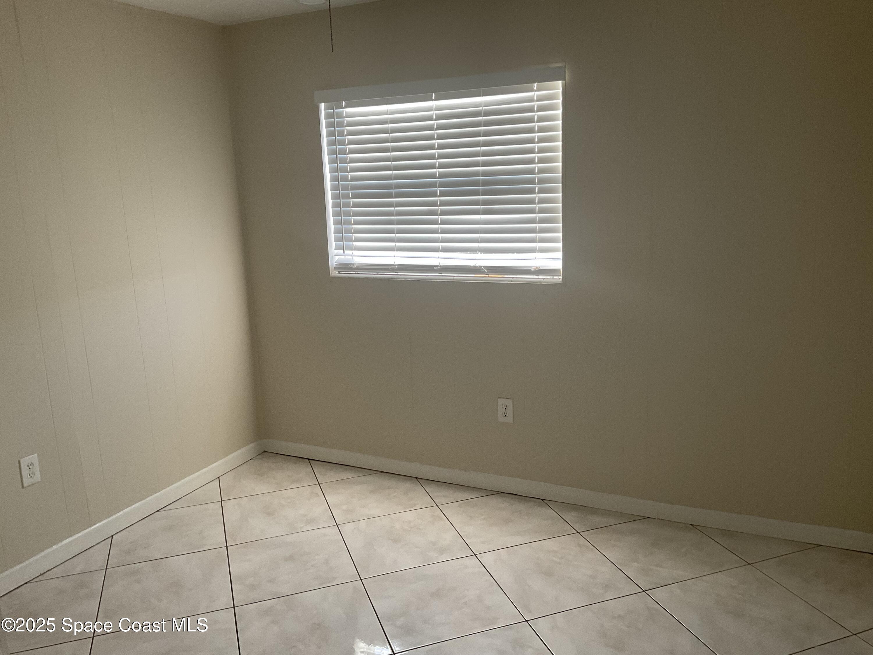 50 Needle Boulevard, Unit 29 Merritt Island, FL 32953 - Photo 7 of 11 a view of an empty room with a window
