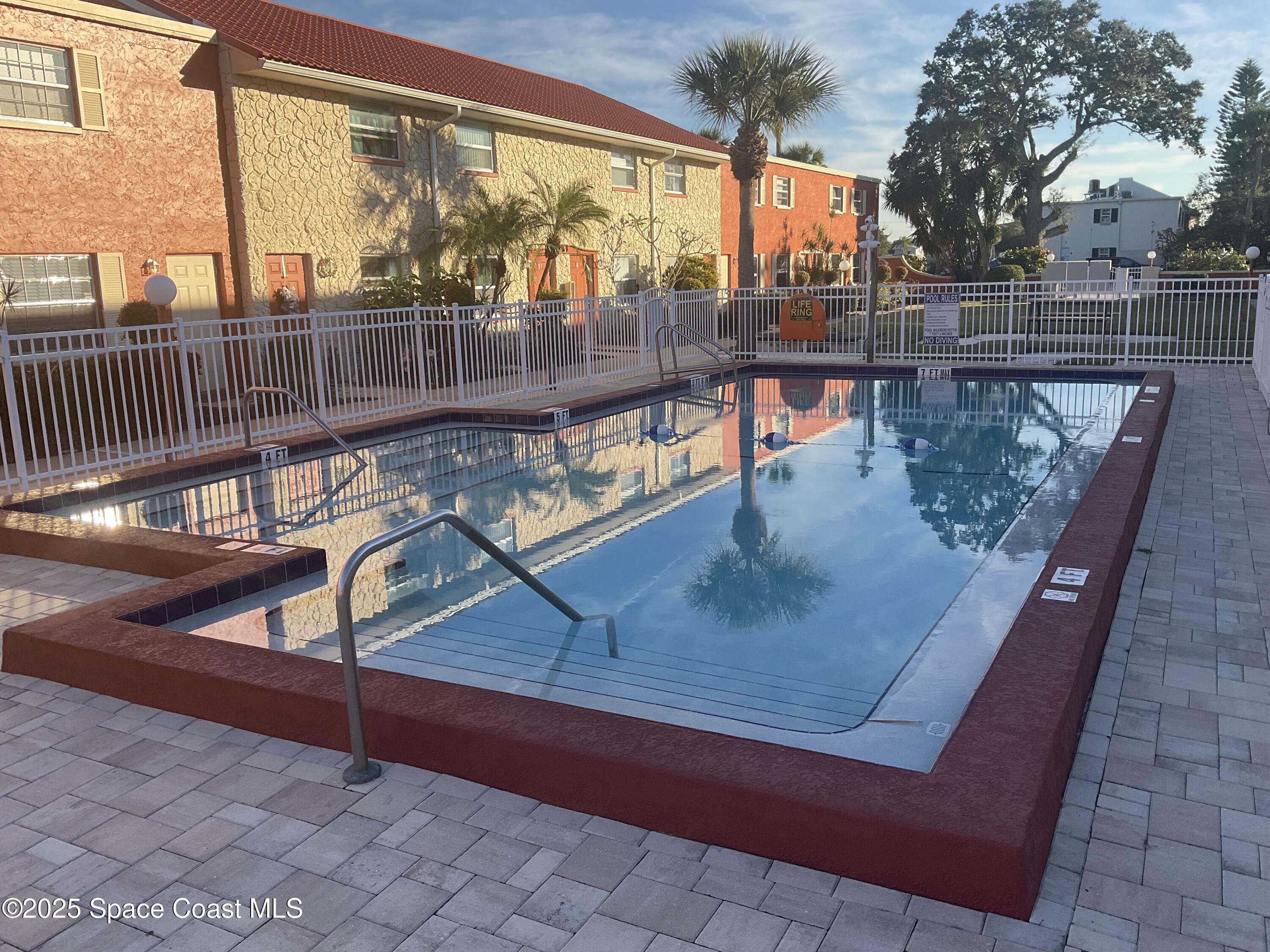 50 Needle Boulevard, Unit 29 Merritt Island, FL 32953 - Photo 10 of 11 a view of a balcony with lake view and wooden floor