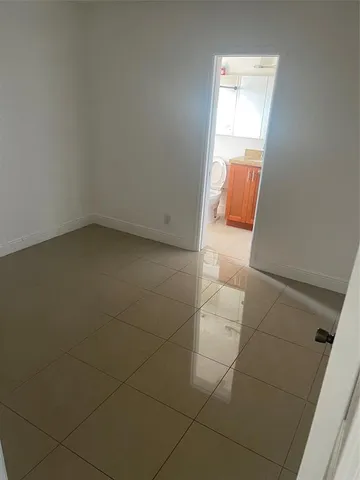a bathroom with a granite countertop toilet and a shower
