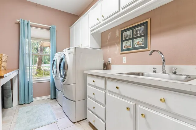 a kitchen with stainless steel appliances a refrigerator sink and cabinets