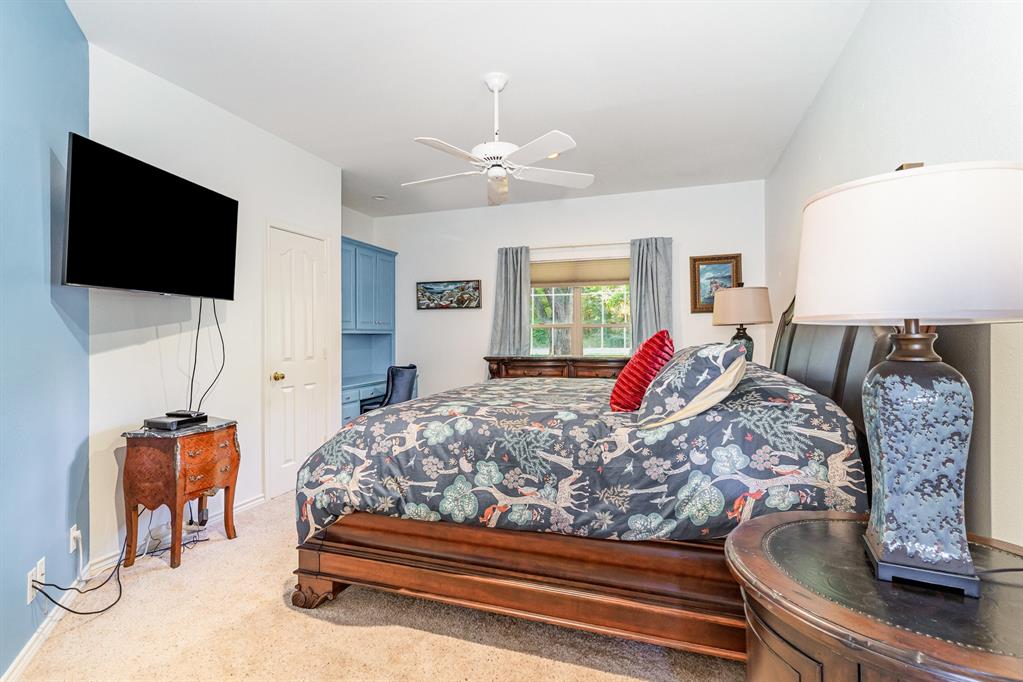 355 Beachside Drive Trinidad, TX 75163 - Photo 21 of 39 a bedroom with a large bed and a flat screen tv