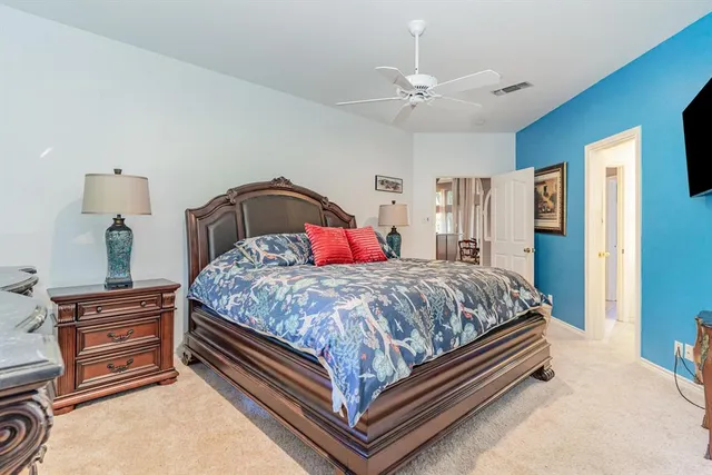 a bed sitting in a bedroom and a chandelier