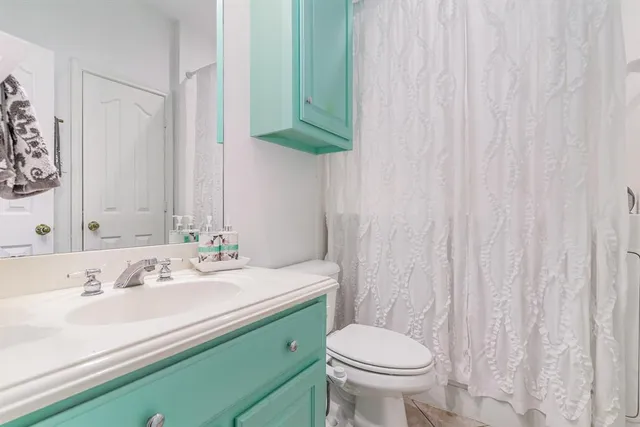 a bathroom with a sink a toilet and a mirror