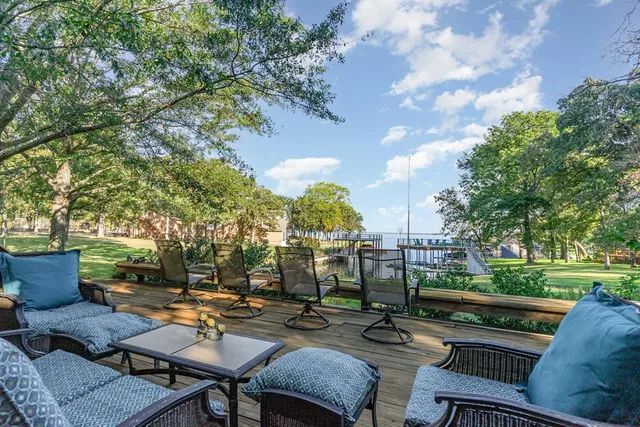 a view of backyard with seating area and green space