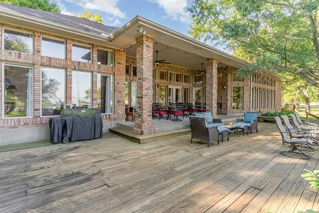 a view of a patio with table and chairs and wooden floor