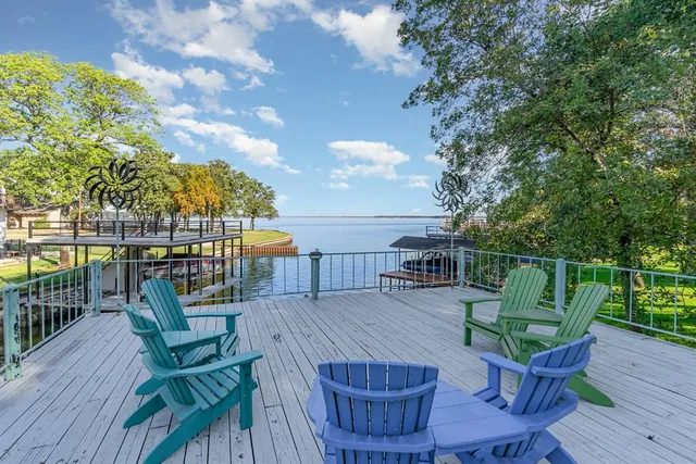 a view of a deck with couches table and chairs with wooden floor
