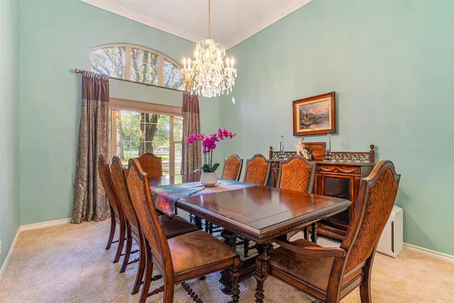 a view of a dining room with furniture and chandelier