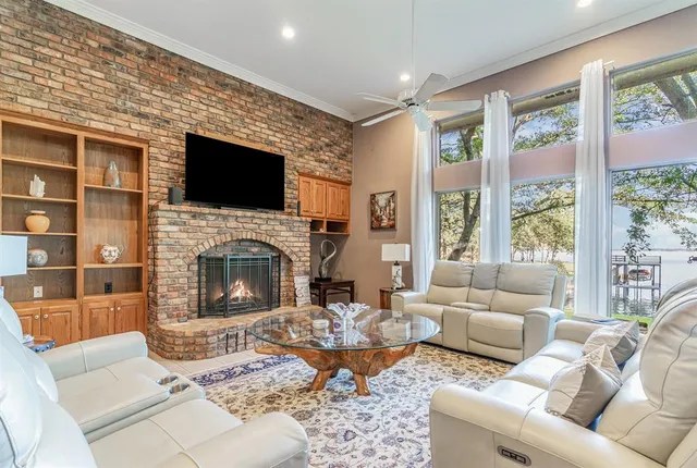 a living room with furniture a flat screen tv and a fireplace