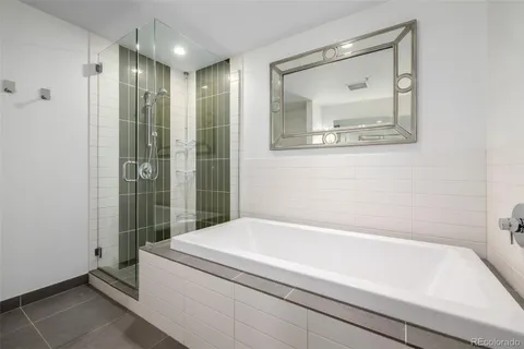 a bathroom with a bathtub and a shower