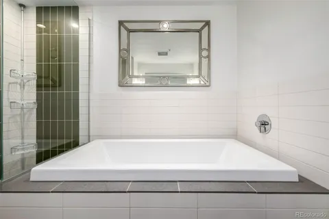 a bathroom with bathtub and shower