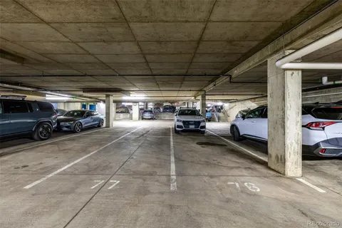 a view of parking garage with cars parked